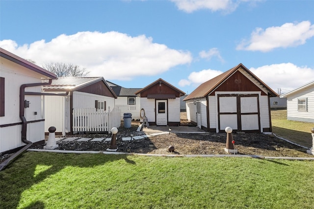 view of yard with a garage, a storage unit, and an outdoor structure