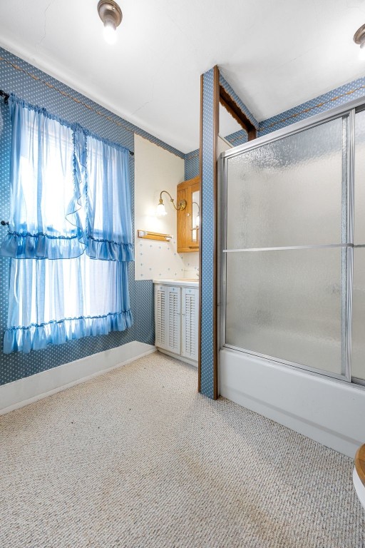 full bathroom featuring shower / bath combination with glass door