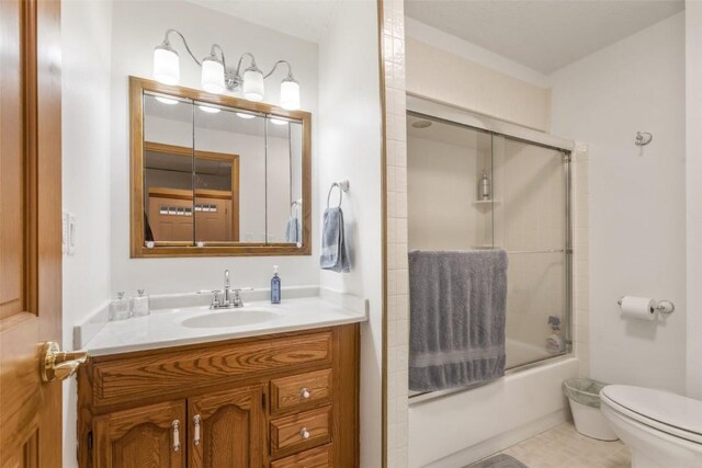 3098 Sandy Beach Rd NE, Solon, IA 52333 - bathroom with vanity, toilet, and bath / shower combo with glass door