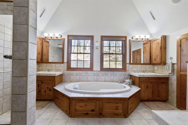 3098 Sandy Beach Rd NE, Solon, IA 52333 - full bath with a sink, visible vents, a garden tub, and vaulted ceiling