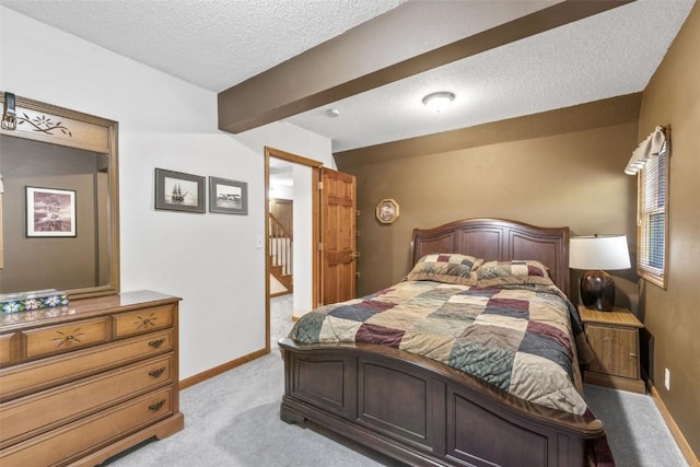 3098 Sandy Beach Rd NE, Solon, IA 52333 - bedroom with beam ceiling, light colored carpet, baseboards, and a textured ceiling