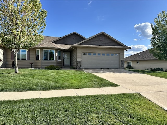 3455 Granger Ave, Marion, IA 52302 - ranch-style home with a garage, a front lawn, concrete driveway, and stone siding