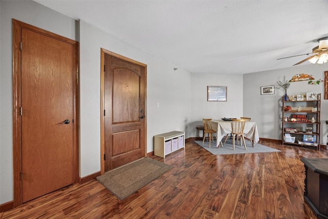 dining area with baseboards, wood finished floors, and a ceiling fan