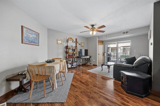 living room featuring visible vents, baseboards, ceiling fan, and wood finished floors