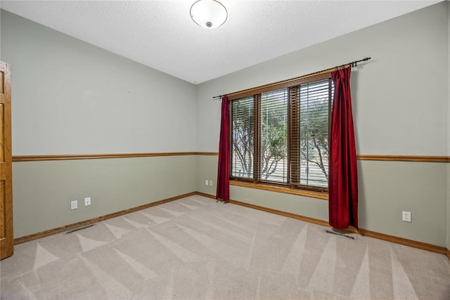 7012 Deer Horn Trl NE, Cedar Rapids, IA 52411 - empty room with baseboards, a textured ceiling, and carpet flooring