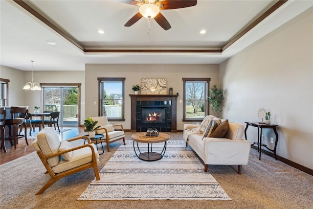 300 Landau St, Robins, IA 52328 - living area with a chandelier, a tile fireplace, a raised ceiling, a ceiling fan, and recessed lighting