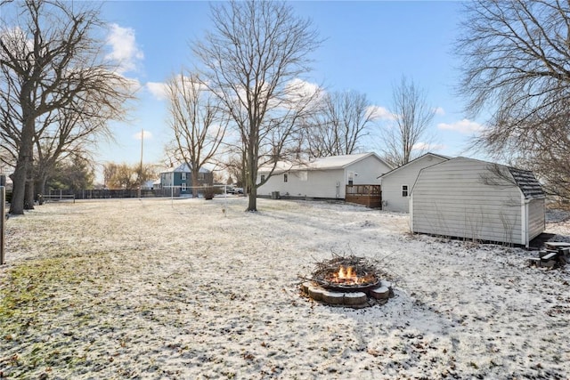 206 E Jackson St, Grandview, IA 52752 - view of yard featuring an outdoor structure, a storage unit, a fire pit, and fence