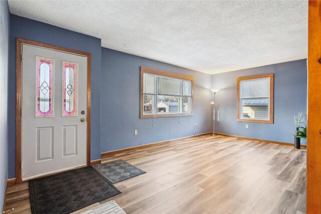 206 E Jackson St, Grandview, IA 52752 - entryway with a textured ceiling, baseboards, and wood finished floors