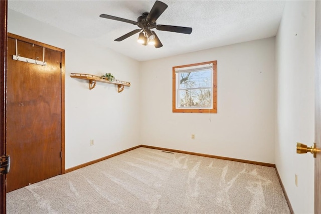 206 E Jackson St, Grandview, IA 52752 - carpeted empty room featuring a ceiling fan, baseboards, and a textured ceiling