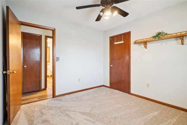 206 E Jackson St, Grandview, IA 52752 - unfurnished bedroom with light carpet, ceiling fan, and baseboards