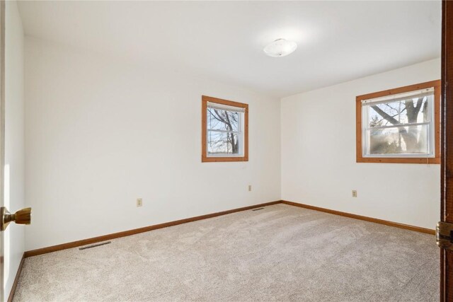 206 E Jackson St, Grandview, IA 52752 - carpeted spare room with visible vents and baseboards