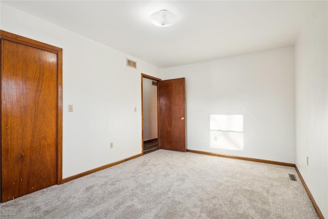 206 E Jackson St, Grandview, IA 52752 - unfurnished bedroom with visible vents, light carpet, and baseboards