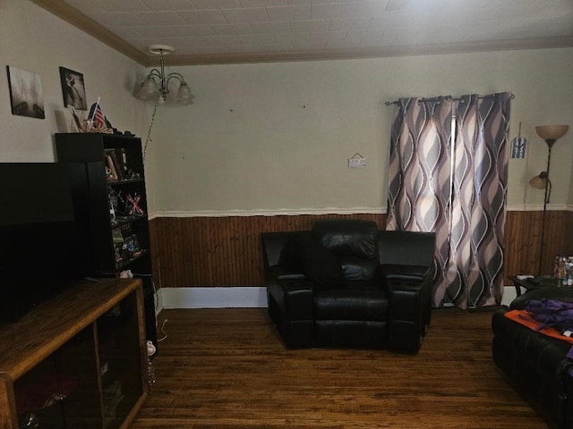 1502 9th Ave, Belle Plaine, IA 52208 - living area featuring ornamental molding, a wainscoted wall, wood finished floors, and wooden walls