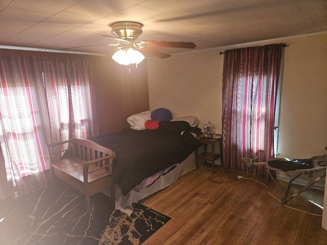 1502 9th Ave, Belle Plaine, IA 52208 - bedroom with crown molding, wood finished floors, and a ceiling fan