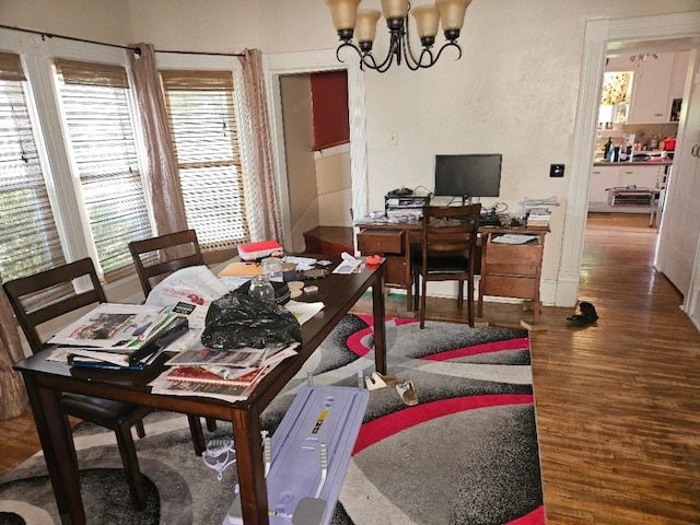 1502 9th Ave, Belle Plaine, IA 52208 - dining room featuring a chandelier, wood finished floors, and an office area