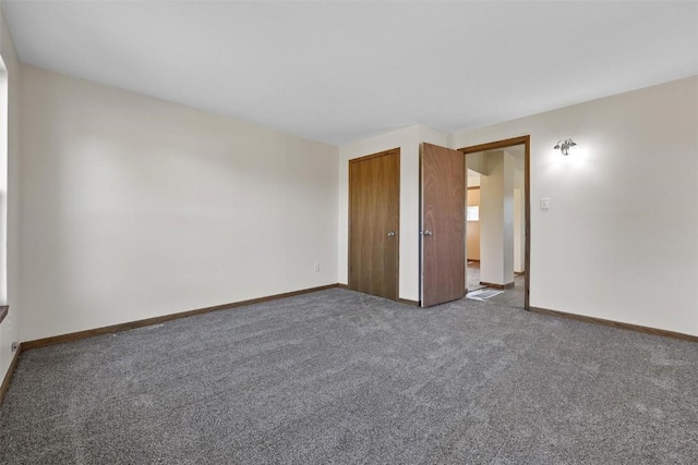 empty room featuring baseboards and carpet floors