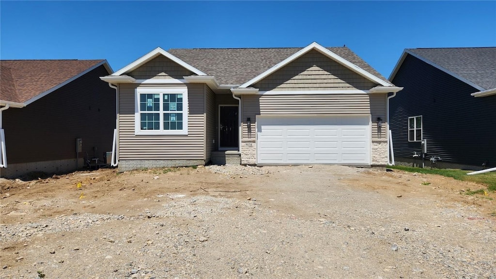9124 Grand Oaks Dr NE, Cedar Rapids, IA 52402 - view of front of house with a garage and driveway