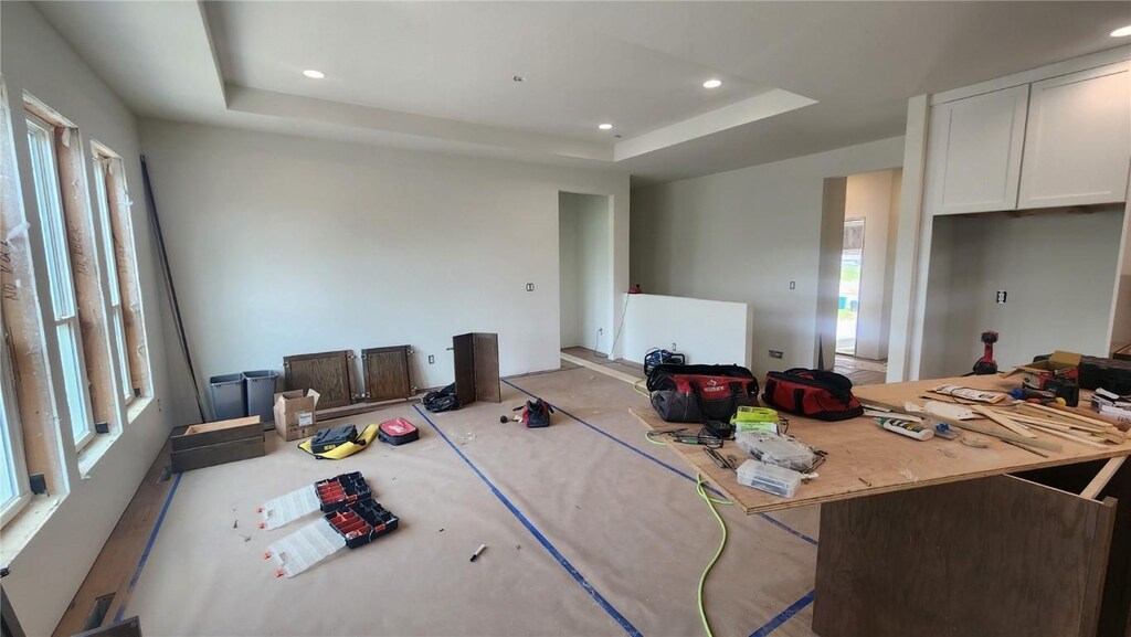 9124 Grand Oaks Dr NE, Cedar Rapids, IA 52402 - carpeted living area with healthy amount of natural light, a raised ceiling, and recessed lighting