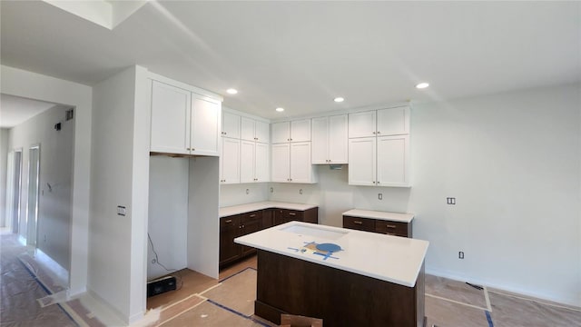 9124 Grand Oaks Dr NE, Cedar Rapids, IA 52402 - kitchen with white cabinetry, a kitchen island, recessed lighting, light countertops, and dark brown cabinetry