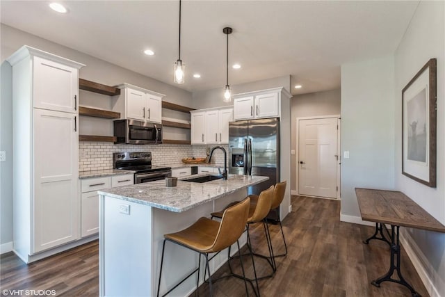 kitchen with baseboards, white cabinetry, open shelves, appliances with stainless steel finishes, and a sink
