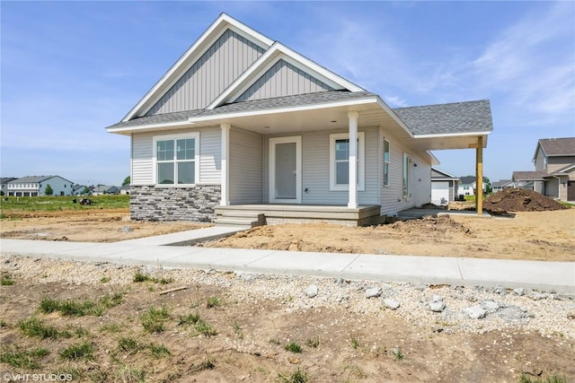 2700 Rookwood Ln, Marion, IA 52302 - view of front of house featuring board and batten siding, covered porch, and roof with shingles