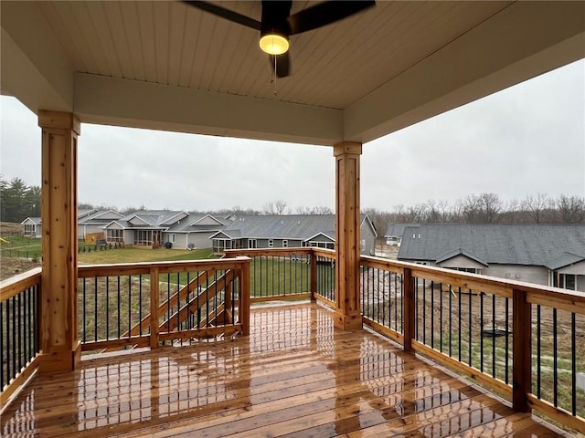 wooden terrace with a ceiling fan and a residential view