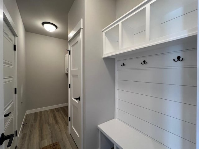 mudroom with dark wood-type flooring and baseboards