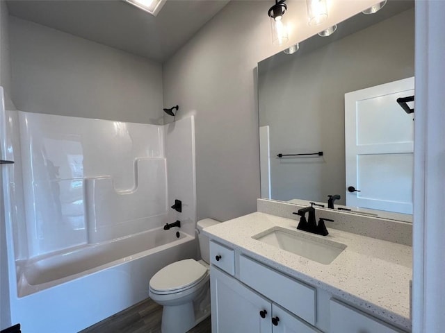 bathroom featuring vanity, shower / tub combination, toilet, and wood finished floors