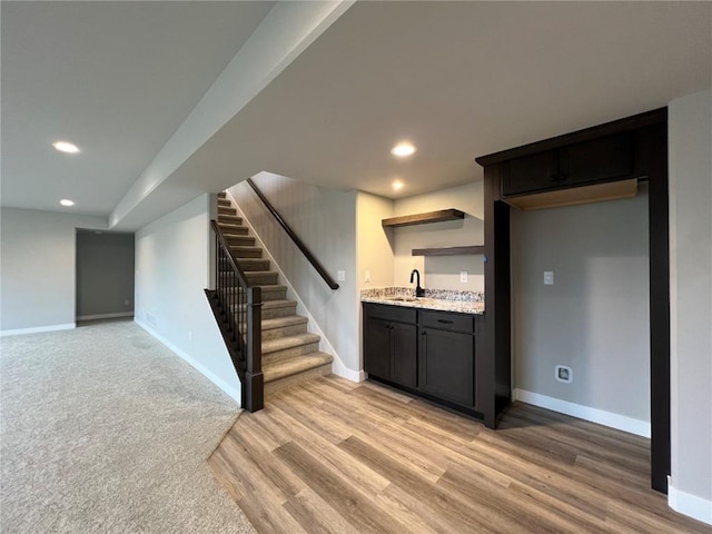 interior space with stairs, indoor wet bar, a sink, and recessed lighting
