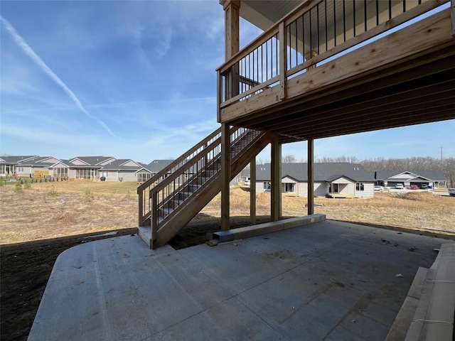 view of patio / terrace with stairway, a residential view, and a wooden deck
