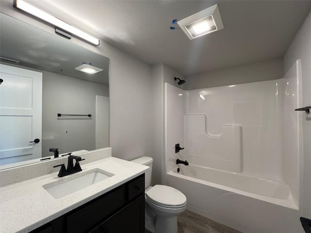 bathroom with toilet, vanity, visible vents, and shower / tub combination