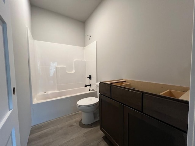 full bathroom with vanity, toilet, wood finished floors, and shower / bath combination