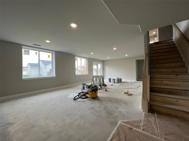 basement featuring stairway, baseboards, and recessed lighting