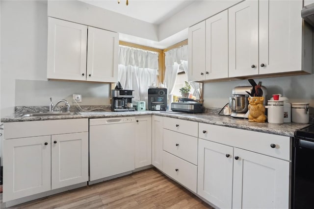 608 W 13th St, Vinton, IA 52349 - kitchen featuring dishwasher, white cabinets, a sink, and light wood-style flooring
