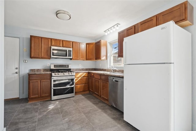 kitchen with a sink, brown cabinets, and appliances with stainless steel finishes