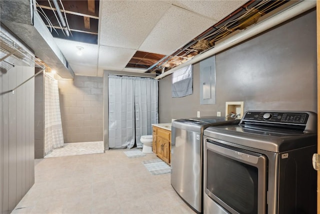 clothes washing area with electric panel, laundry area, and separate washer and dryer
