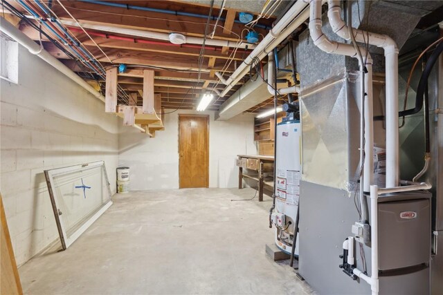 unfinished basement featuring water heater and heating unit