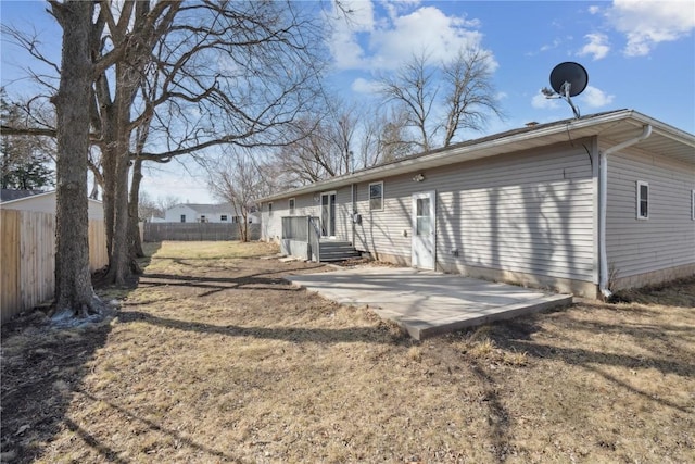 back of property featuring fence and a patio