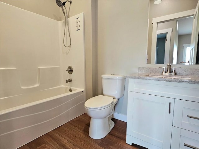 7936 217th Ave, Martelle, IA 52305 - full bath featuring vanity, wood finished floors, tub / shower combination, toilet, and baseboards