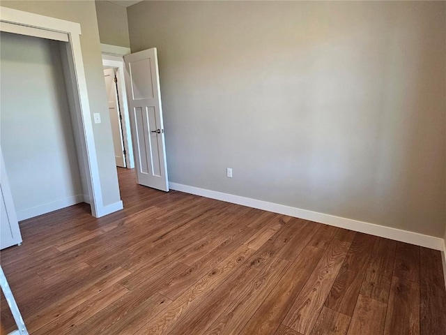 7936 217th Ave, Martelle, IA 52305 - unfurnished bedroom featuring baseboards, wood finished floors, and a closet