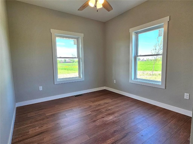 7936 217th Ave, Martelle, IA 52305 - spare room with plenty of natural light, dark wood-style floors, and ceiling fan