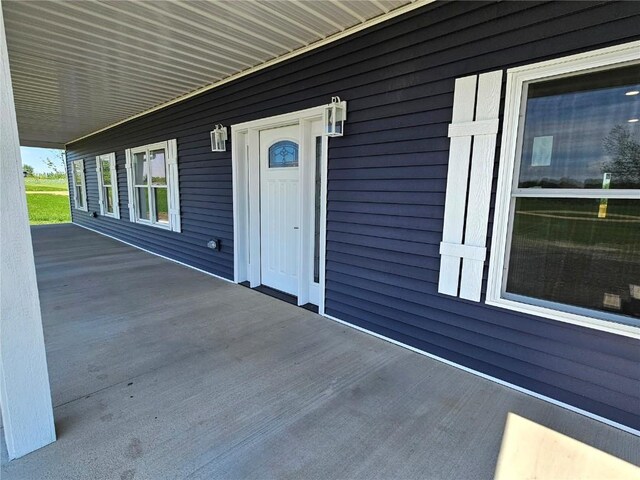 7936 217th Ave, Martelle, IA 52305 - view of exterior entry featuring covered porch