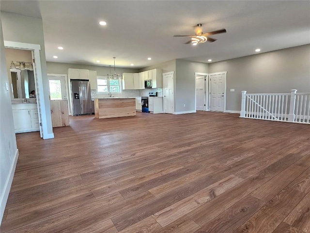 7936 217th Ave, Martelle, IA 52305 - kitchen featuring stainless steel appliances, open floor plan, dark wood-type flooring, a ceiling fan, and white cabinets