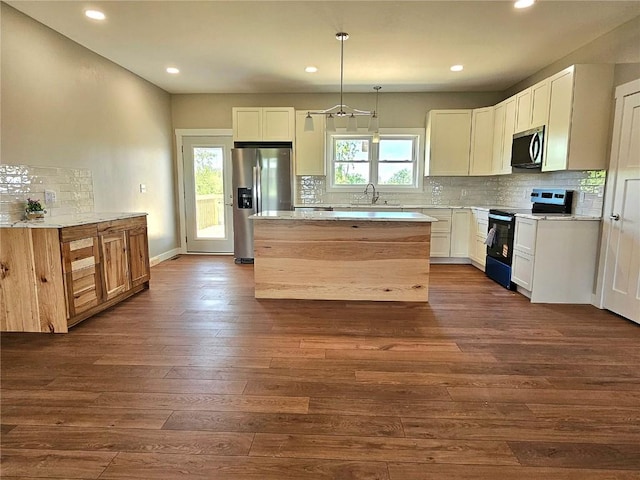 7936 217th Ave, Martelle, IA 52305 - kitchen with stainless steel appliances, backsplash, light countertops, recessed lighting, and dark wood-style flooring