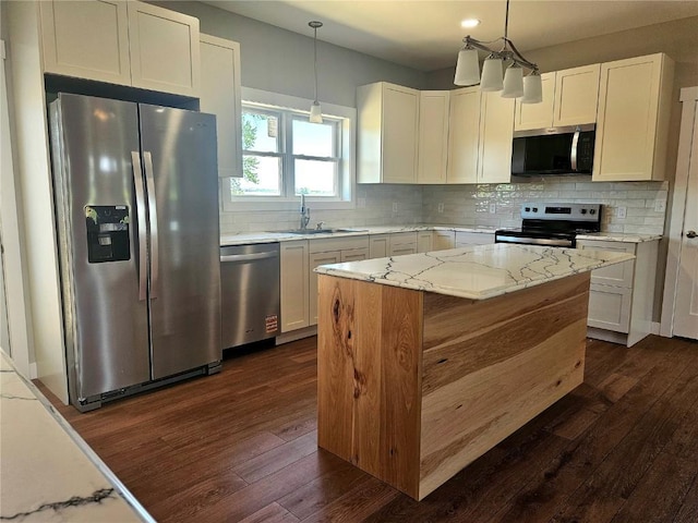 7936 217th Ave, Martelle, IA 52305 - kitchen with stainless steel appliances, a sink, dark wood-style flooring, and light stone countertops