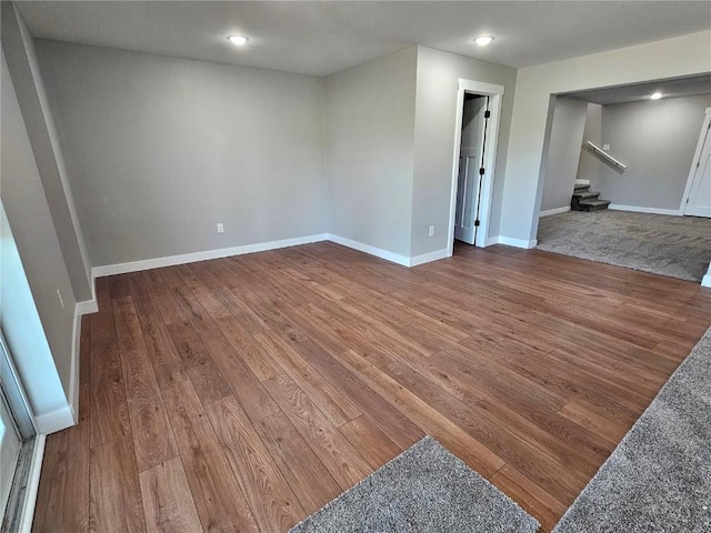 7936 217th Ave, Martelle, IA 52305 - unfurnished room featuring hardwood / wood-style floors, stairs, baseboards, and recessed lighting