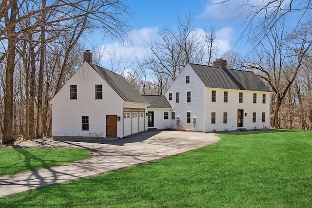 view of property exterior featuring a lawn, concrete driveway, and a chimney