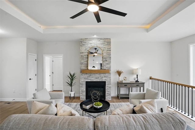 878 Silver Ln, Iowa City, IA 52245 - living room with a ceiling fan, a raised ceiling, and wood finished floors