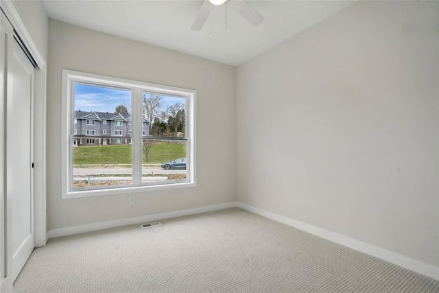 878 Silver Ln, Iowa City, IA 52245 - spare room featuring carpet flooring, baseboards, and a ceiling fan