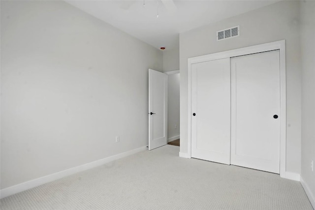 878 Silver Ln, Iowa City, IA 52245 - unfurnished bedroom with light colored carpet, baseboards, a closet, and a ceiling fan